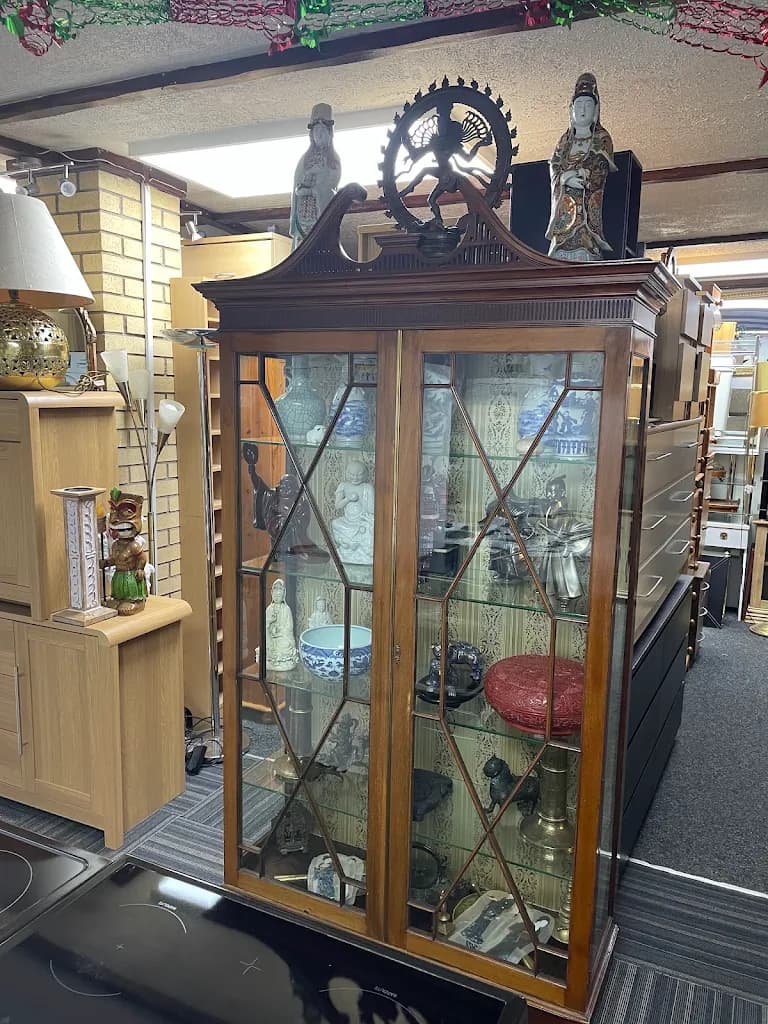 An antique display cabinet, one of the many collectible pieces that pass through the Odds 'n' Ends showroom